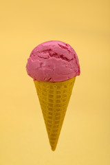 Pink ice cream on a yellow background