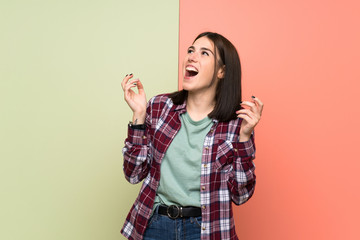 Young woman over isolated colorful wall smiling a lot