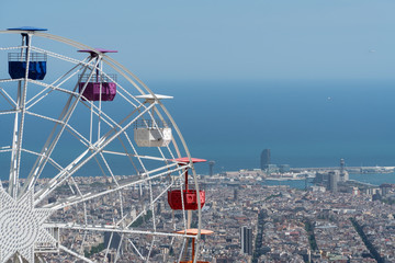 Ferris Wheel at Tibidabo amusement park in Barcelona with city view at the background