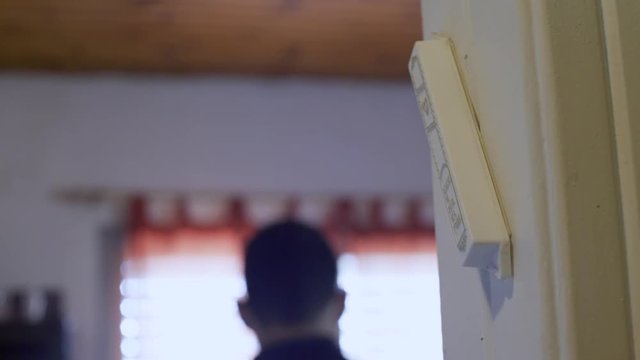 Man touches and kisses a Jewish mezuzah (door protector) 