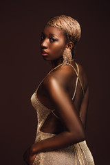 beautiful fashionable african american girl with short hair isolated on brown