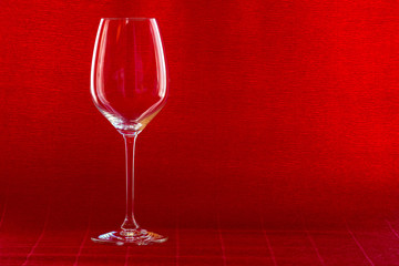 Wine glass on red background