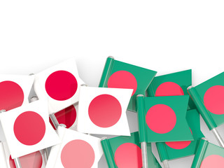 Pins with flags of Japan and bangladesh isolated on white.