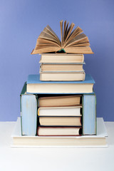 Open book, hardback colorful books on wooden table. Back to school. Copy space for text. Education business concept.