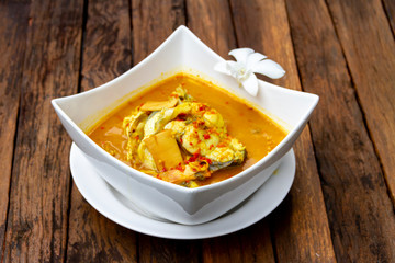 SEAFOOD - KAENG SOM PLA KAPONG : HOT AND SPICY DELICIOUS SEABASS IN YELLOW CURRY LOCAL THAI FOOD.