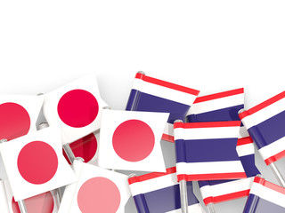 Pins with flags of Japan and thailand isolated on white.