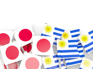 Pins with flags of Japan and uruguay isolated on white.