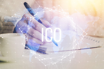 Cryptocurrency hologram over hands taking notes background. Concept of blockchain. Multi exposure