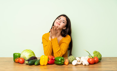 Fototapeta premium Teenager girl with many vegetables applauding after presentation in a conference
