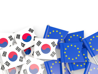 Pins with flags of South Korea and EU isolated on white.