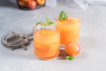 Healthy apricot juice on rustic background