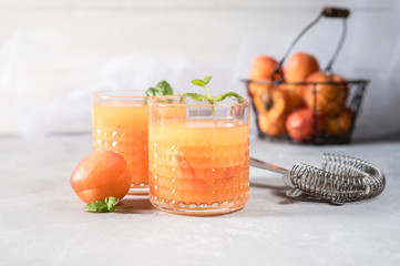 Healthy apricot juice on rustic background