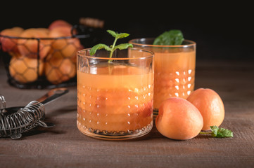 Healthy apricot juice on rustic background