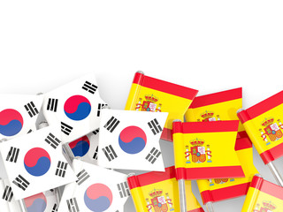 Pins with flags of South Korea and spain isolated on white.