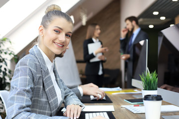 business woman with her staff, people group in background at modern bright office indoors.