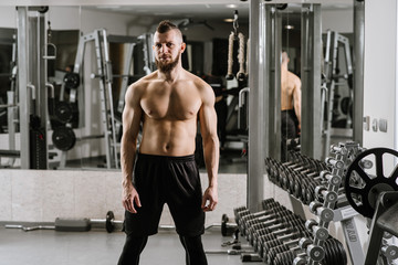 Fototapeta premium Strong muscular man ready for exercises in the gym
