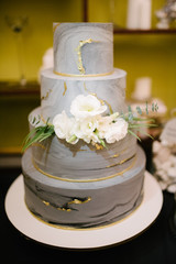 Obraz na płótnie Canvas Big white wedding cake with fruit is on the table