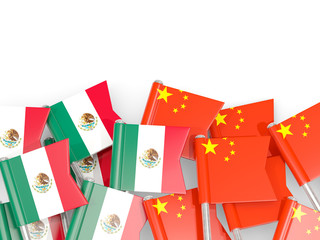 Pins with flags of Mexico and china isolated on white.