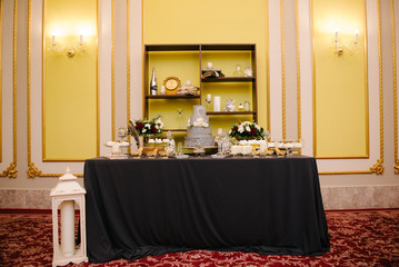 Big white wedding cake with fruit is on the table