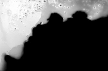 Spilled milk puddle isolated on black background and texture with clipping path, top view