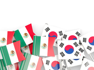 Pins with flags of Mexico and south korea isolated on white.