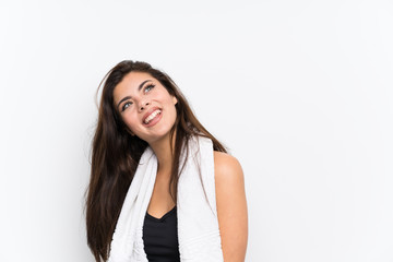 Teenager sport girl over isolated white background laughing and looking up