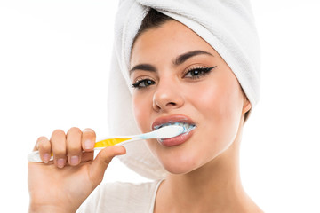 Teenager girl over isolated white background brushing her teeths