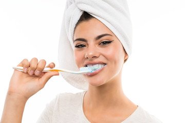 Teenager girl over isolated white background brushing her teeths