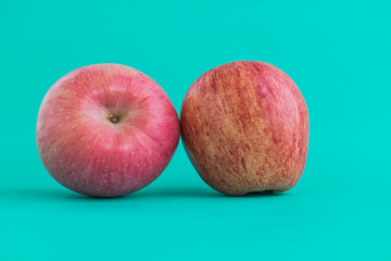 Red apple on colored background