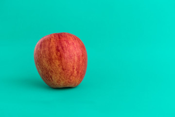 Red apple on colored background