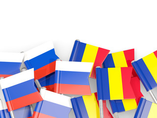 Pins with flags of Russia and romania isolated on white.