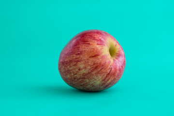 Red apple on colored background
