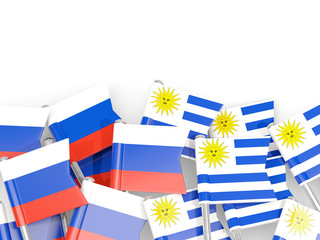 Fototapeta na wymiar Pins with flags of Russia and uruguay isolated on white.