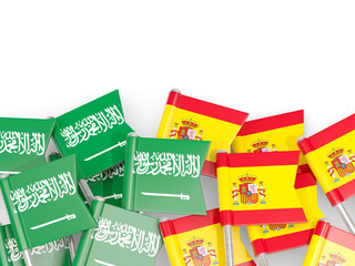 Pins with flags of Saudi Arabia and spain isolated on white.