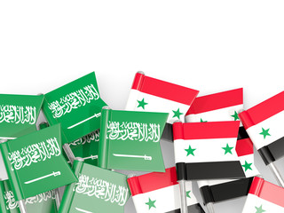 Pins with flags of Saudi Arabia and syria isolated on white.