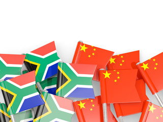 Pins with flags of South Africa and china isolated on white.