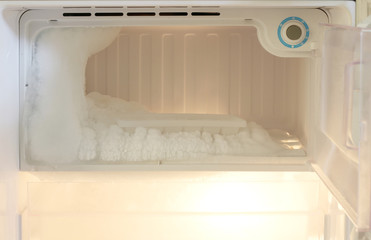 Fototapeta na wymiar Ice on freezing compartment of refrigerator.