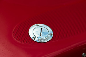 Chrome fuel tank cap. Fuel cap on a red sports boat. Metallic gas tank cap