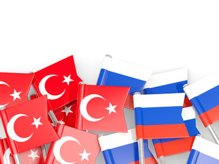 Pins with flags of Turkey and russia isolated on white.