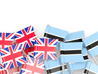 Pins with flags of UK and botswana isolated on white.