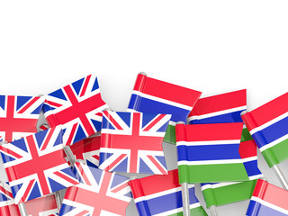Pins with flags of UK and gambia isolated on white.