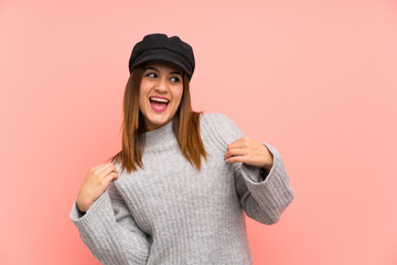 Fashion woman with hat over pink wall proud and self-satisfied