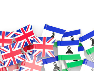Pins with flags of UK and lesotho isolated on white.