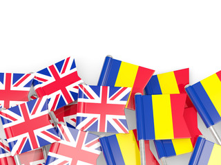 Pins with flags of UK and romania isolated on white.