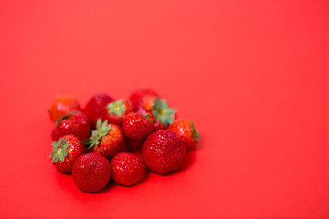 Strawberries on red background