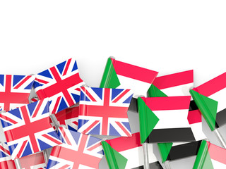 Pins with flags of UK and sudan isolated on white.