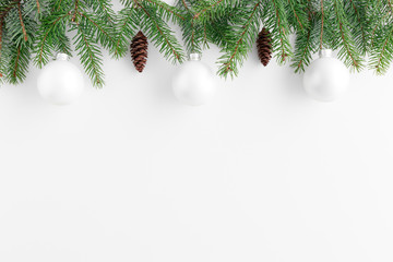 Pine cones and leaves with christmas balls on a white table. Flat lay with blank copy space.