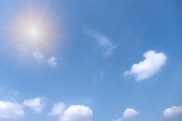 Beautiful white clouds with sun on blue sky.Color shade gradient from white to blue for background wallpaper.