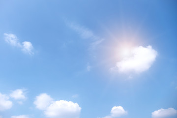 Beautiful white clouds with sun on blue sky.Color shade gradient from white to blue for background wallpaper.