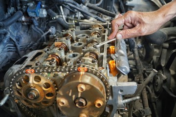 Automotive mechanic checking the auto engine. The powerful engine of a car. Motor engineering concept.